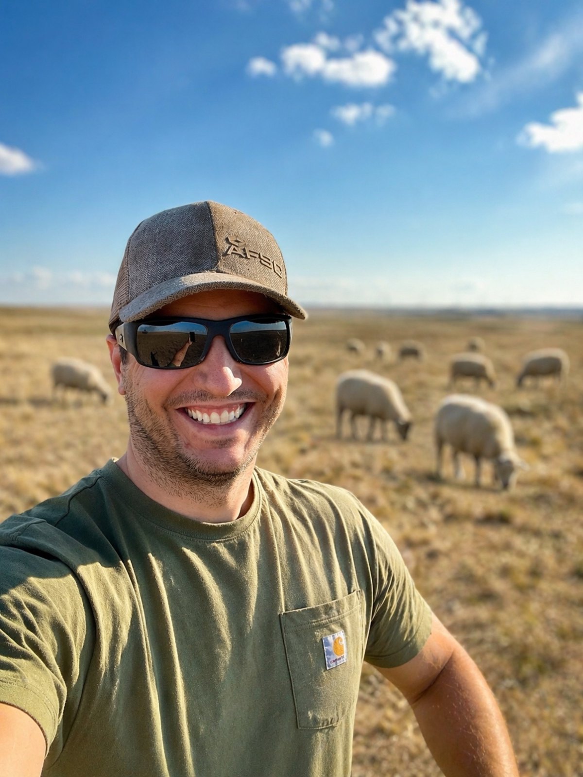 Eric Steeves on family grassland in Vulcan County, Alberta, with sheep grazing in the background.